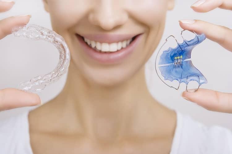patient holding orthodontic appliances in prahran