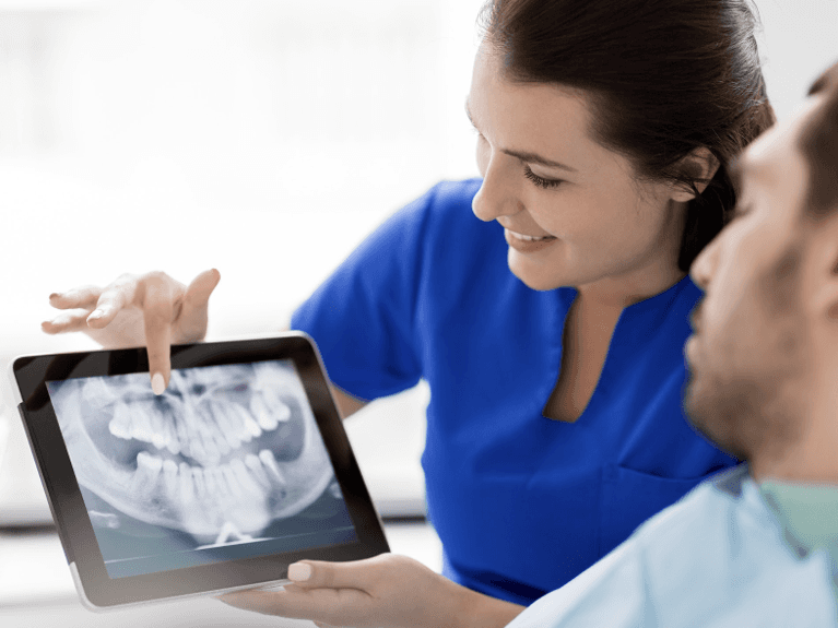 dentist in prahran reviewing x-rays with patient