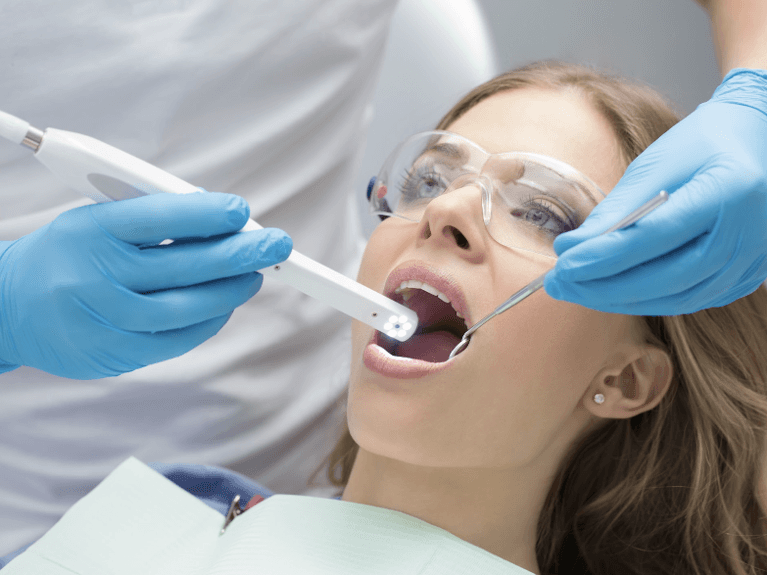 patient with dentist in prahran getting images taken of mouth with intraoral camera