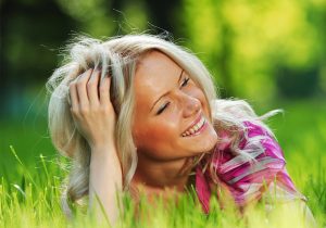 Smiling woman lying in the grass
