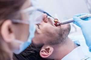 Dentist looking in the mouth of a patient