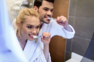 Male and Female cleaning teeth