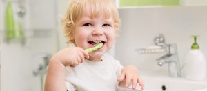 Happy child brushing his teeth