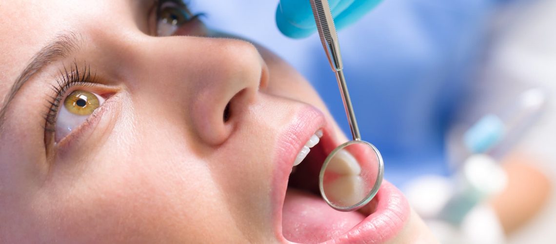 Dentist looking in the mouth of a calm patient